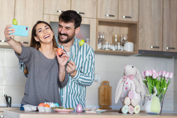 istock Attractive young parents taking a selfie celebrating Easter at home 1387107131