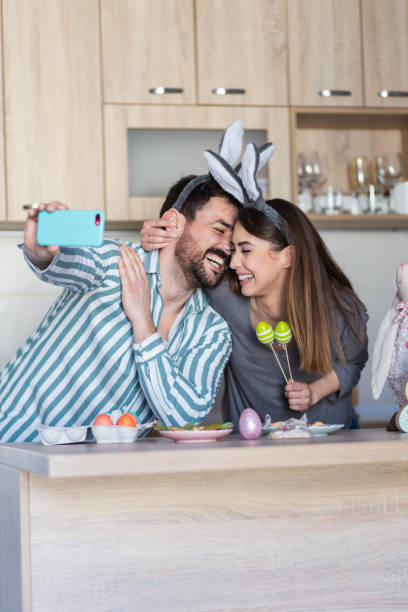 istock Attractive young parents taking a picture together for Easter touching foreheads 1387107165