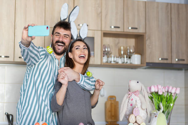 istock Beautiful young couple taking a picture for Easter 1387107171