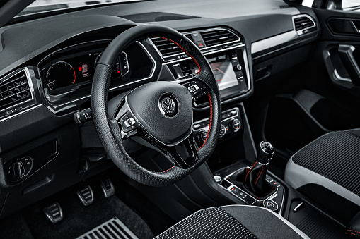 Barnaul, Russia 11.07.2021. Interior of Volkswagen Tiguan crossover. Details of steering wheel with logo and instrument panel. First-person view. Editorial use.