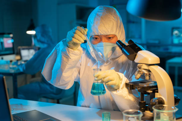 istock Contemporary female researcher or virologist testing liquid substance 1387108197