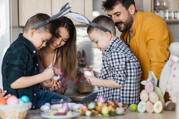 istock Happy family painting Easter eggs 1387108401