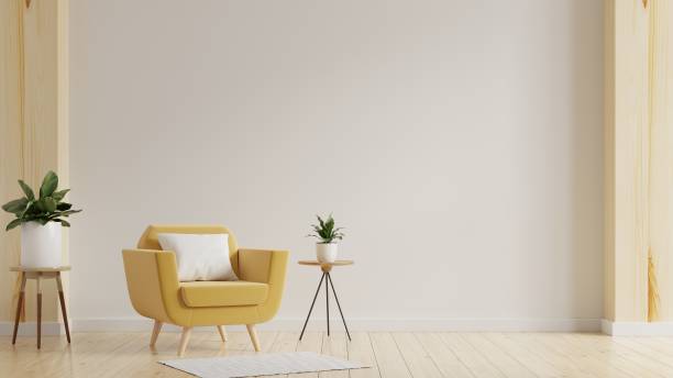 istock Modern minimalist interior with an yellow armchair on empty white wall background. 1387109436