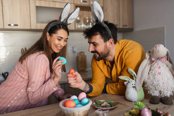 istock Young couple cracking colorful Easter eggs as an Orthodox Greek tradition 1387109534