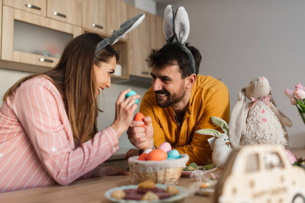istock Attractive young couple cracking colorful Easter eggs as a part of Orthodox Green tradition 1387109593