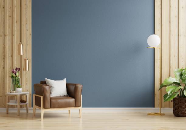 istock Armchair on empty dark blue wall background. 1387109722