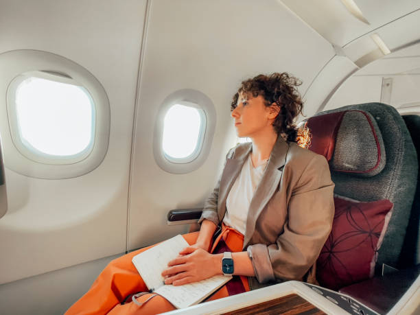 istock A Pensive Caucasian Female Looking Through The Window While Being On A Plane 1387110846