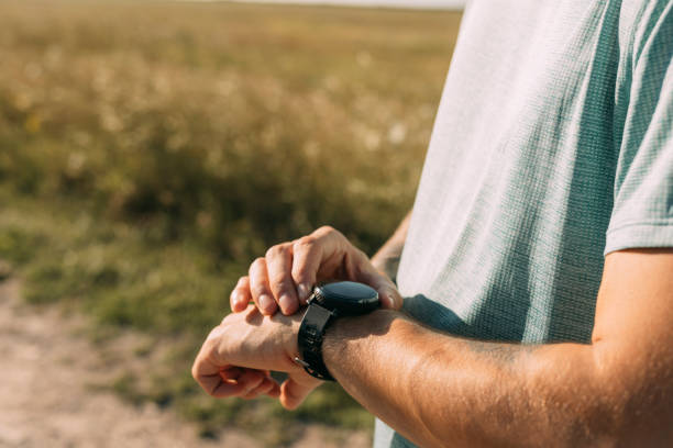 istock Anonymous Male Runner Checking his Time on a Smartwatch 1387111126