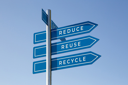 Reduce, reuse and recycle words on signpost isolated on sky background. Environment care concept