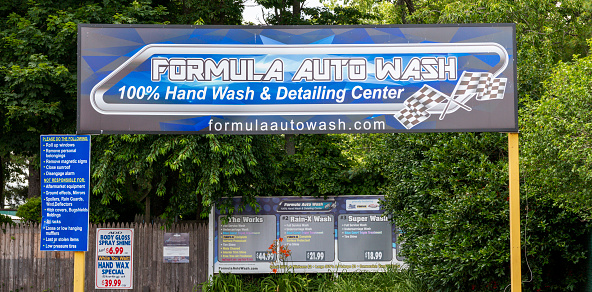 West Islip, NEw York, USA - 25 June 2021: Formula auto car wash and detailing center entrance for drive through.