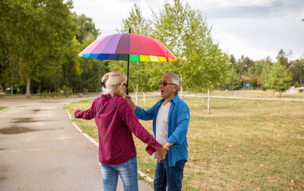istock Couple walking in wet day 1387117702