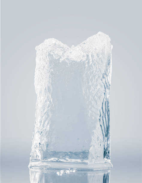 istock Crystal clear, pure ice block, on a light blue surface with reflection. A big piece of ice. 1387119483