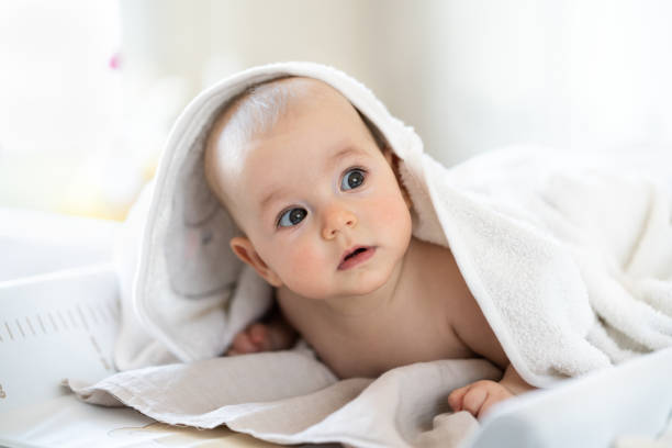 istock Baby wearing towel after bath 1387123866