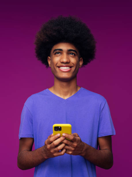 Portrait of funny afro guy using phone