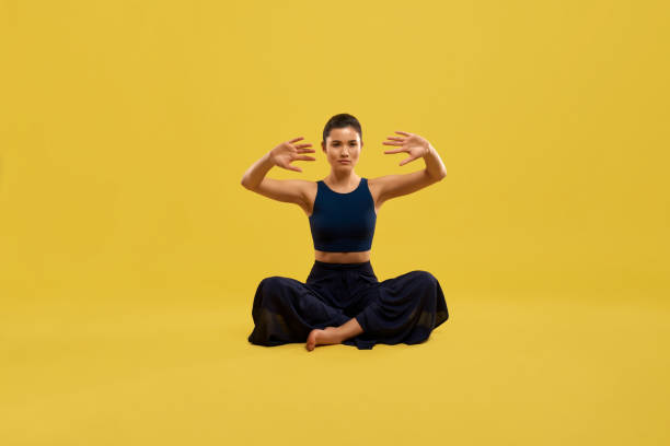 istock Young female sitting on floor, doing yoga. 1387125720