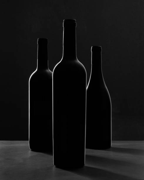 Three wine bottles in silhouette - fotografia de stock