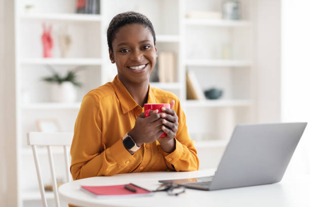 Cheerful millennial black woman freelancer working from home