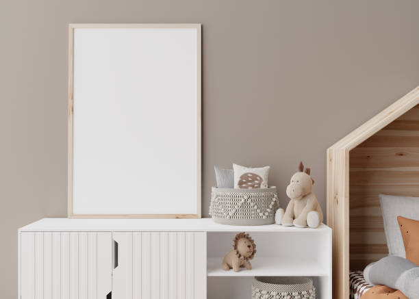 istock Empty vertical picture frame on brown wall in modern child room. Mock up interior in scandinavian style. Free, copy space for your picture. Close up view. Cozy room for kids. 3D rendering. 1387128623