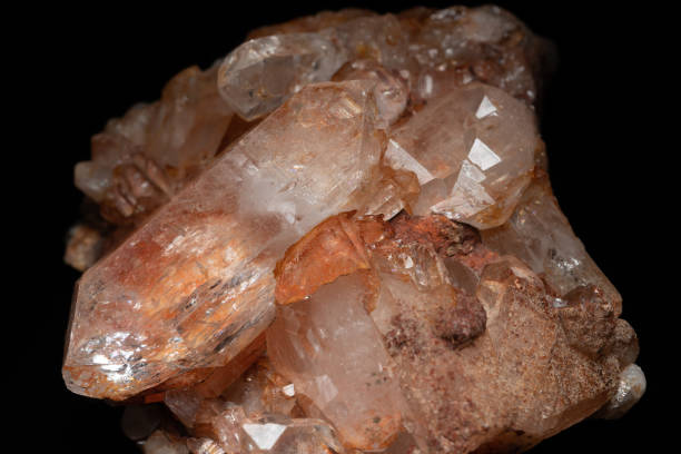 istock Natural Quartz crystal cluster on black background, selective focus. Pure crystalline mineral. Extremely hard and sharp rock found in river. Macro close up of glassy smoky brown orange Quartz crystal. 1387135479