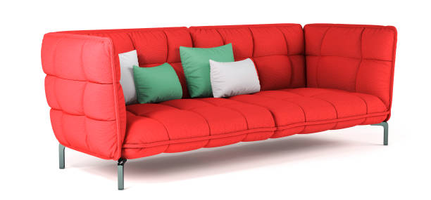 istock Modern red quilted fabric sofa on metal legs with pillows on isolated white background. Furniture, interior object. Bright scarlet sofa. 1387137071