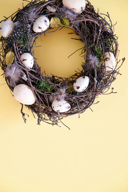 istock Easter Decoration with Easter Wreath and Eggs on Yellow Background 1387138612