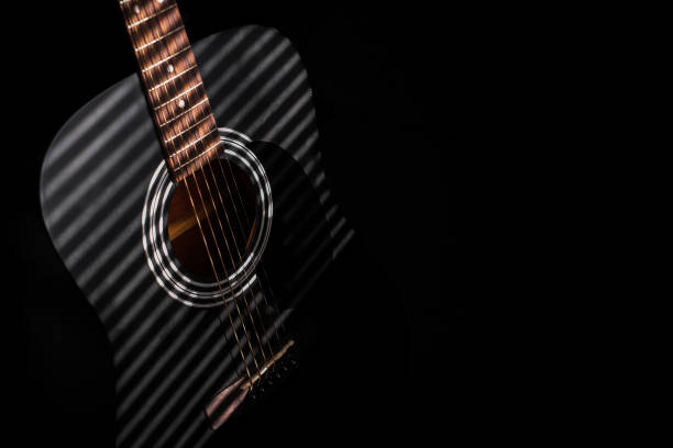 istock Musical instrument black guitar close-up on a dark background 1387139291