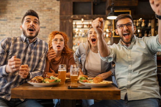 istock Young people watching soccer game 1387140685
