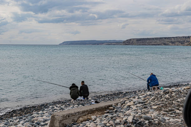 January 21, 2018, Kourion Beach, Cyprus\nPeople fishing on the beach at Kourion on Cyprus on a calm winters day.