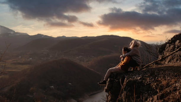 istock Young people on mountain hike at sunset 1387141776