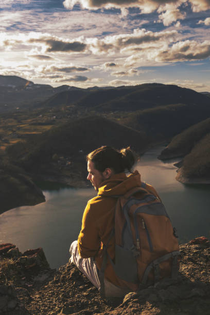 istock Young people on mountain hike at sunset 1387141901