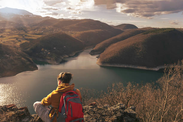 istock Young people on mountain hike at sunset 1387141919