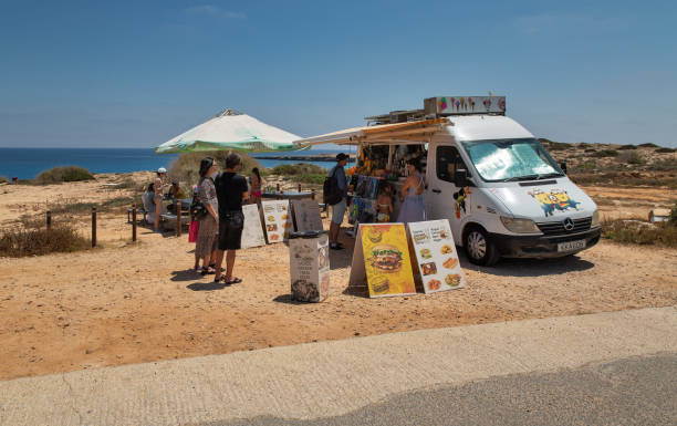 Ayia Napa, Cyprus - May 27, 2021: People visit mobile cafe shop close to Cape Greco. Cape Greco, or Capo Greco, is a headland in the southeastern part of the island of Cyprus.