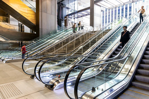 Sydney, Australia - March 20, 2022: Entry to the Wynyard train station new modern escalator and travellers