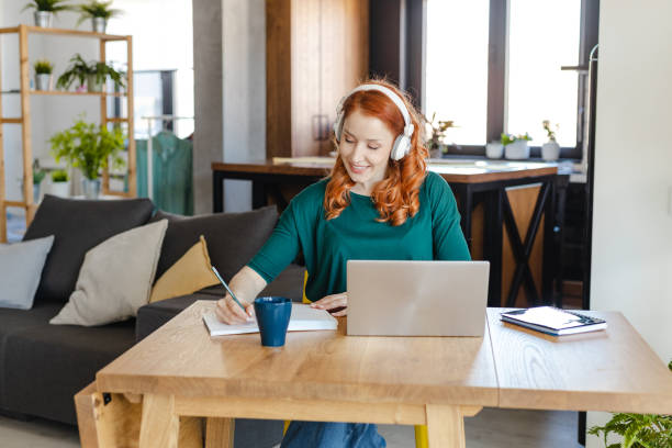 istock Young woman working remotely at home 1387142213