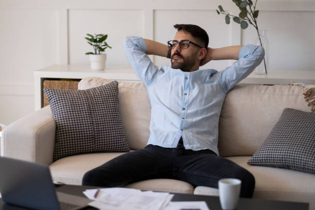 istock Calm young man relax in chair at home workplace 1387142297