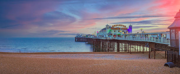 Brighton Pier during Sunset in England, UK The Brighton Palace Pier, commonly known as Brighton Pier or the Palace Pier,[a] is a Grade II* listed pleasure pier in Brighton, England east sussex stock pictures, royalty-free photos & images