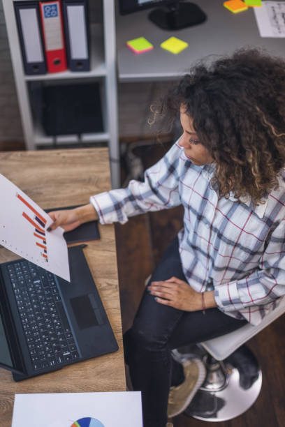 istock Young woman working  in the office 1387143153