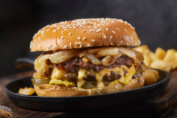 the juicy lucy stuffed cheeseburger with fried onions - sesame bun american culture cheddar imagens e fotografias de stock