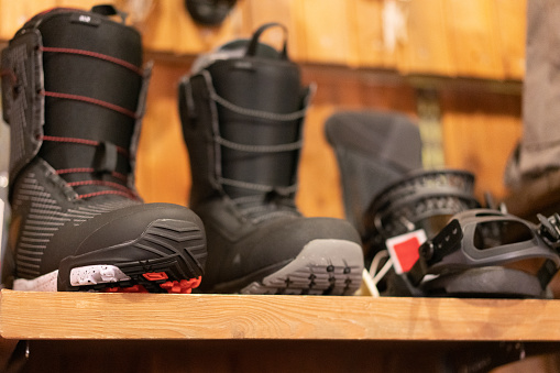 Group of snow boots standing on shelf in shop