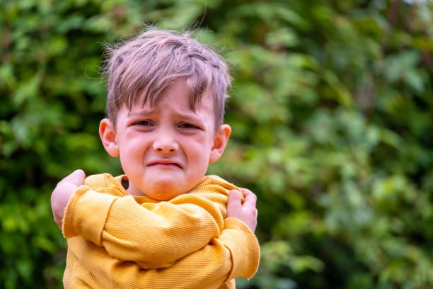 istock Sad little boy looking at the camera 1387144349