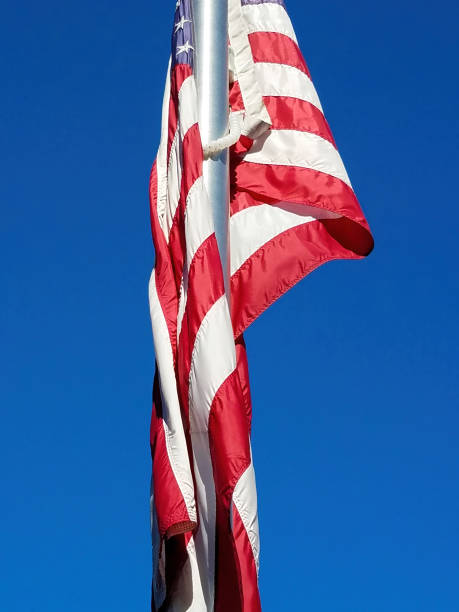 istock American Flag Hanging On A Flagpole 1387146884
