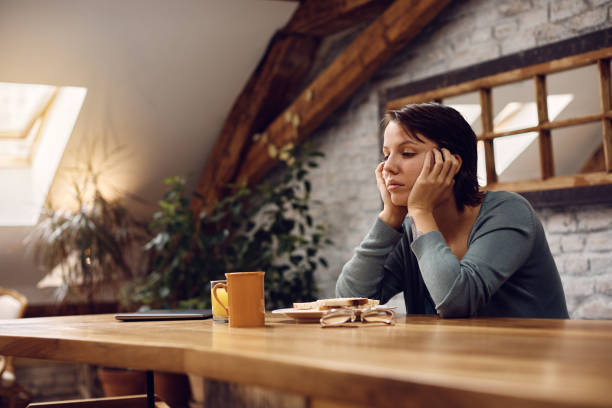 pensive woman has no will to eat because she is feeling depressed at home. - eating sandwich emotional stress food imagens e fotografias de stock