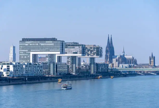 Cologne, Germany, March 2022: Rhine River at Cologne Rheinauhafen and view to Cologne Cathedral (Kölner Dom)