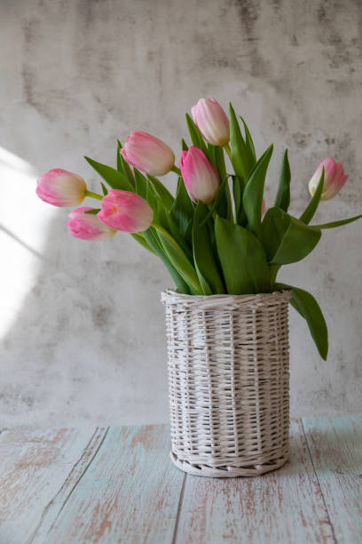 istock Vase of willow branches with pink tulips 1387148448