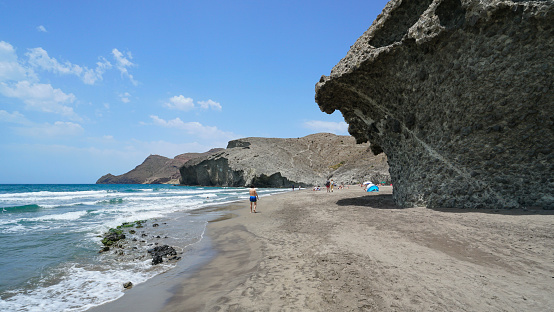 Spain Mediterranean coast in Andalusia, sandy beach shore with volcanic rock formation, Playa de Monsul, Cabo de Gata Nijar natural park, Almeria