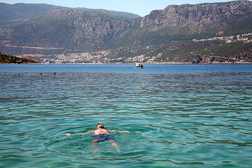 Antalya, Turkey - July 12, 2012: People swimming on mediterranean sea in kaş coast at summer. View of landscape kaş antalya.