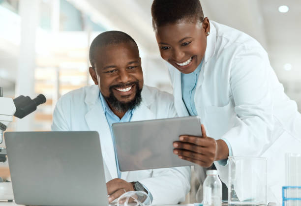 istock Shot of two scientists using a laptop and digital tablet in a laboratory 1387148711