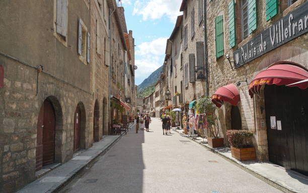 Villefranche de Conflent village street France VILLEFRANCHE DE CONFLENT, FRANCE, PYRENEES ORIENTALES "u2013 06/06/2019: touristic street lined by old houses in the medieval village villefranche de conflent stock pictures, royalty-free photos & images