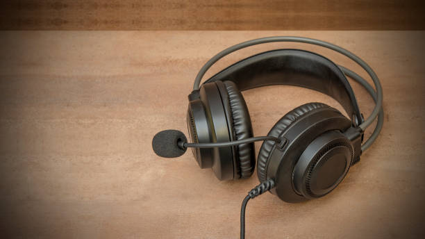 istock Black headphone closeup view on office table customer care concept 1387154282