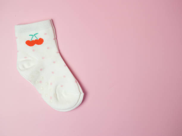 istock children's colorful socks on a pink background 1387154701